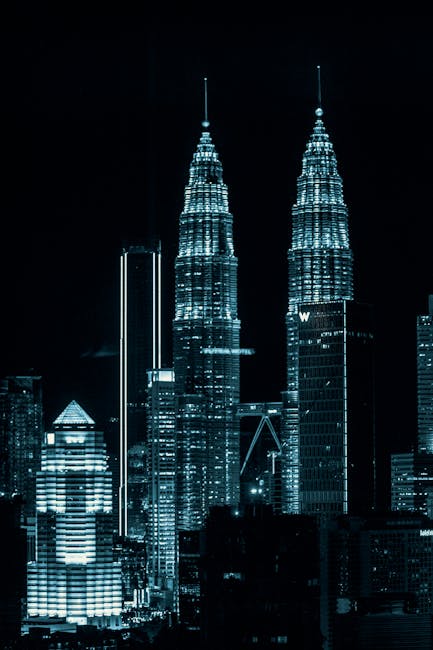 Dazzling night view of Kuala Lumpur cityscape showcasing the iconic Petronas Twin Towers.